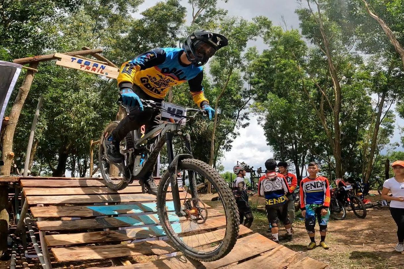 A rider clearing the drop at the Teban Trail start gate during a race