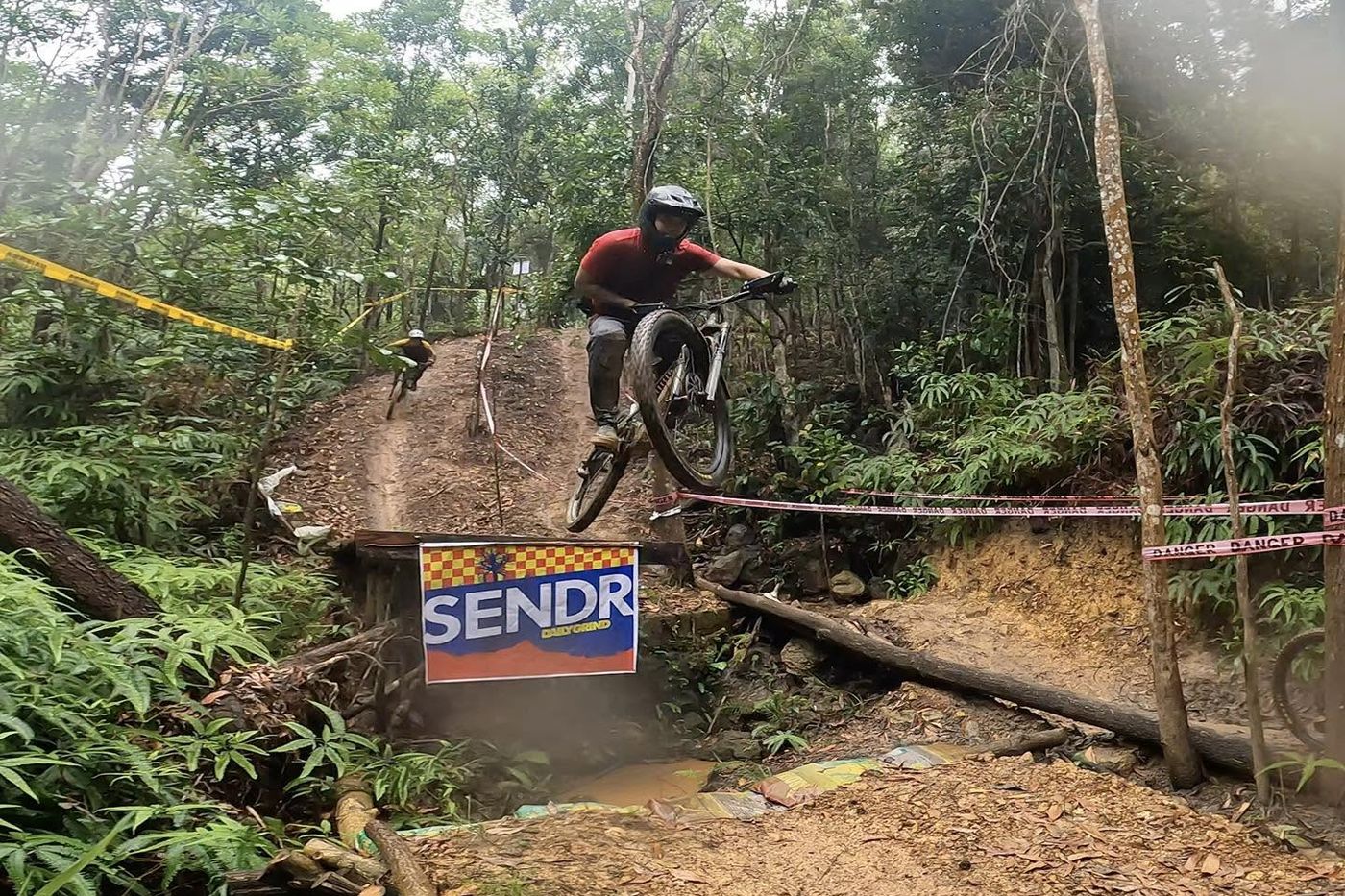 A rider sending the gap jump over a Sendr banner